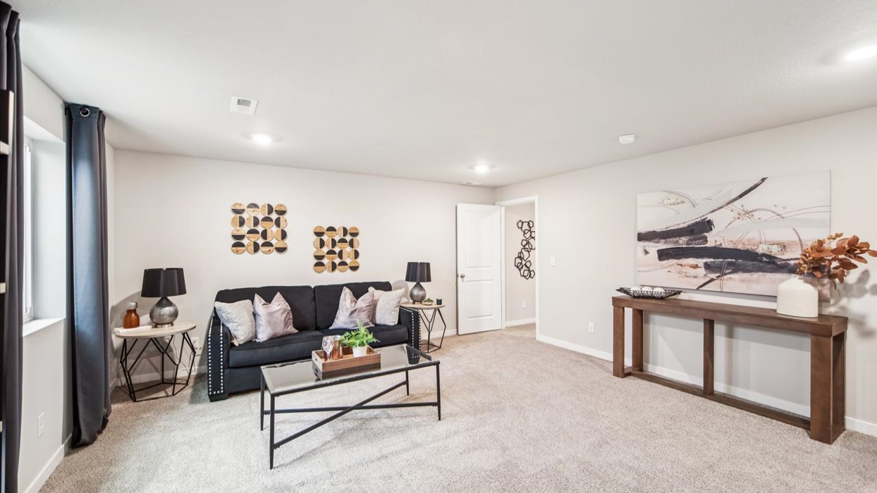 Finished basement living area with comfortable seating space and flexible room for entertaining or relaxing.
