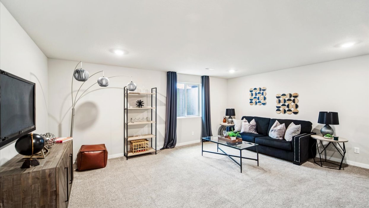 Finished basement living area with comfortable seating space and flexible room for entertaining or relaxing.