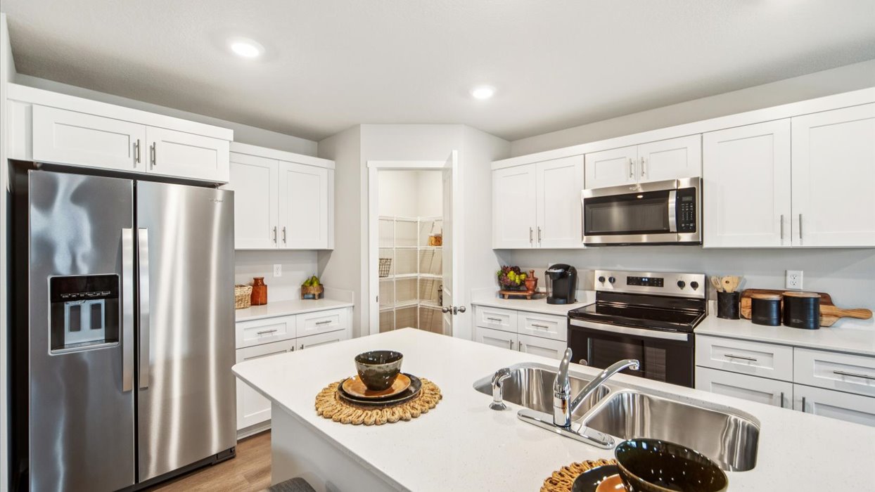 Kitchen with white cabinetry and quartz countertop
