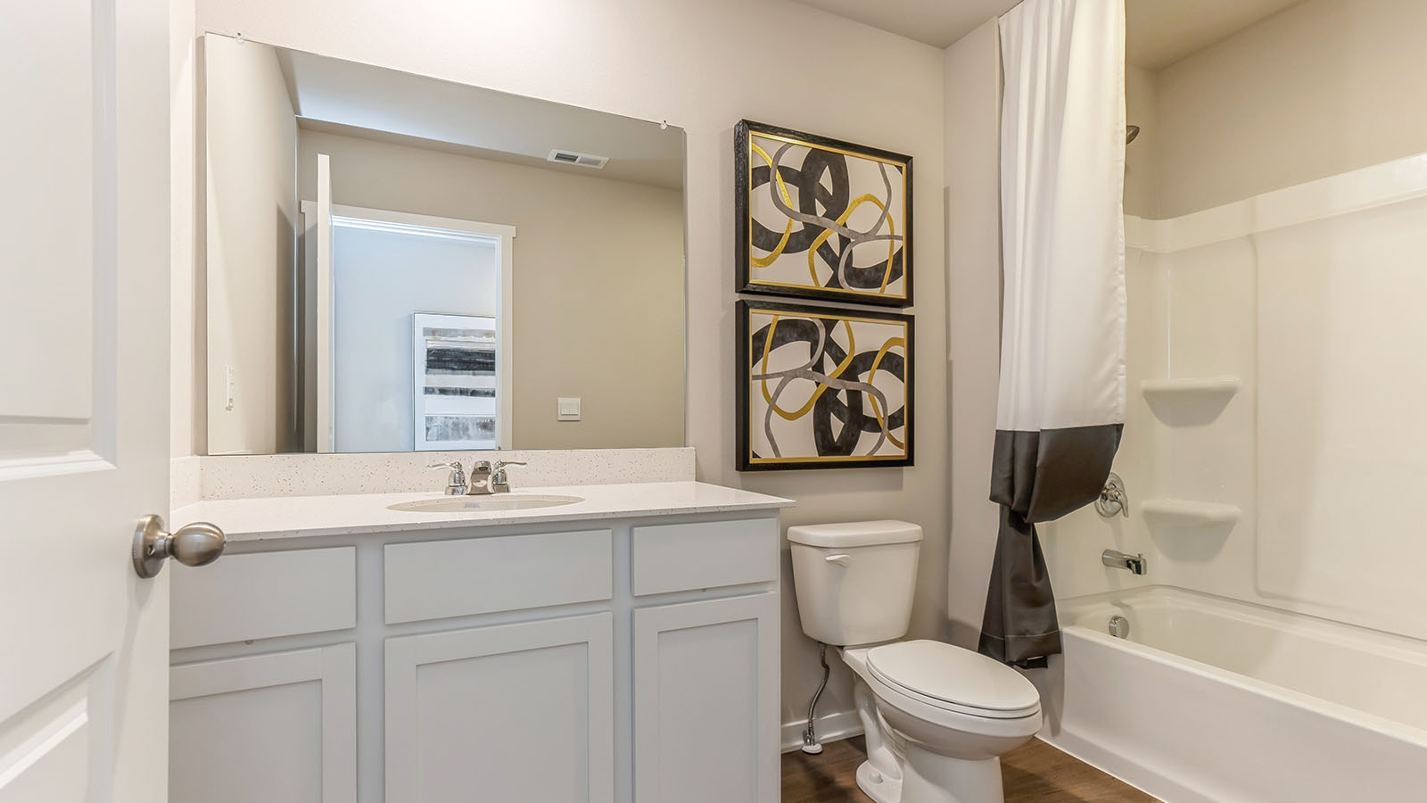 Bathroom with tub and shower combo, quartz countertops, and white vanity