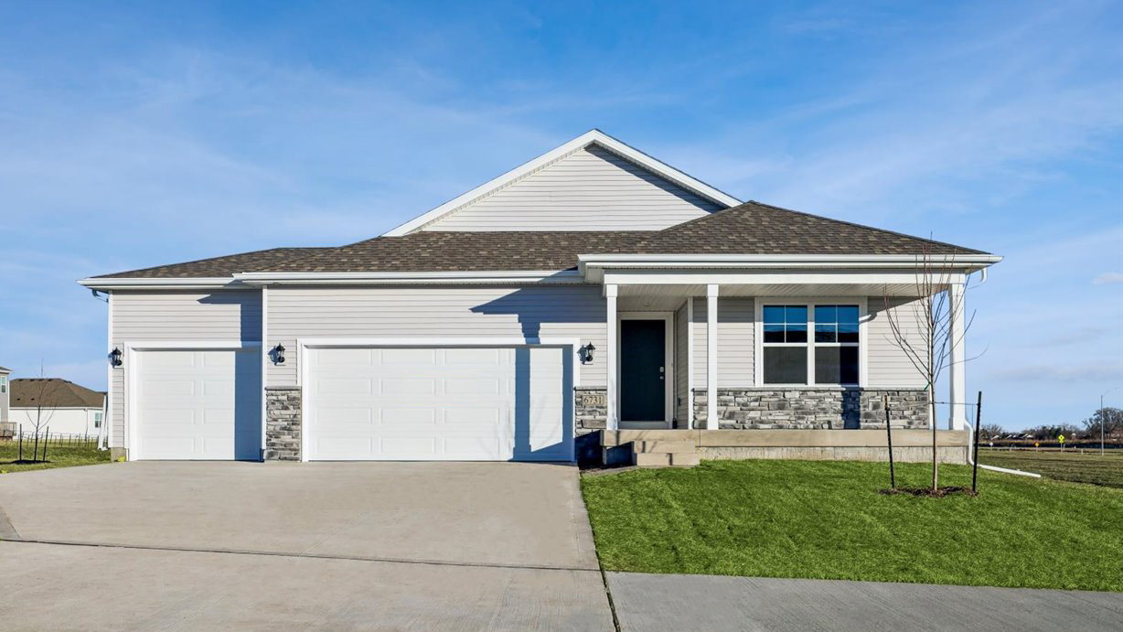 front exterior of neuville home with 3 car attached garage