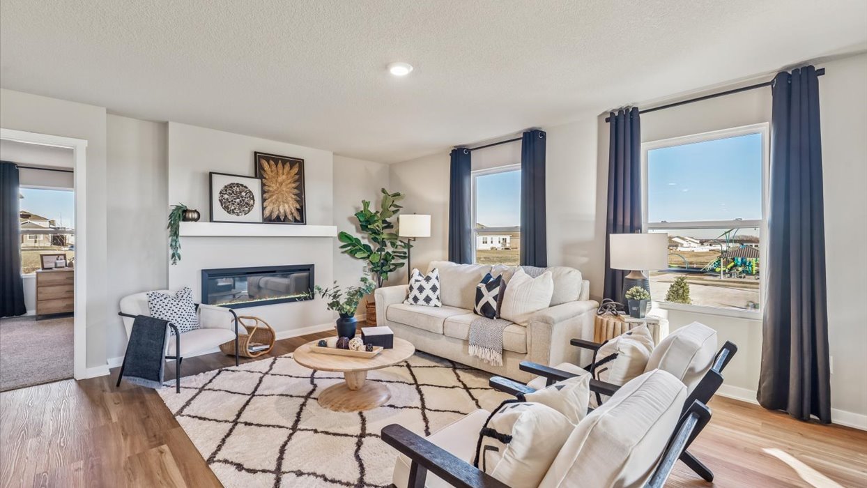 neuville living room with two big windows and electric fireplace
