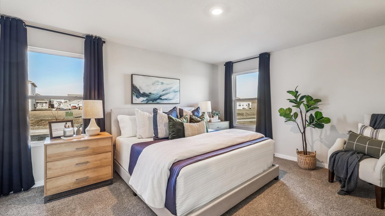 bright primary bathroom with white bed and nightstands