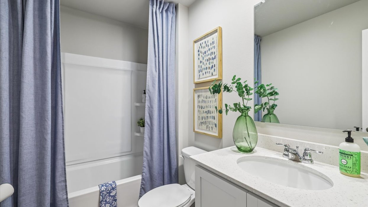 Stylish full bathroom with bright lighting and functional design.