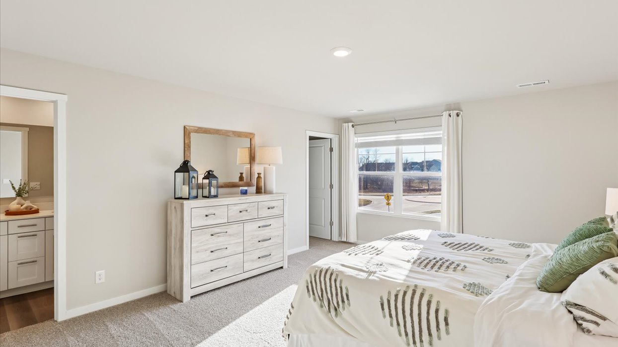Primary bedroom with natural lighting and spacious layout