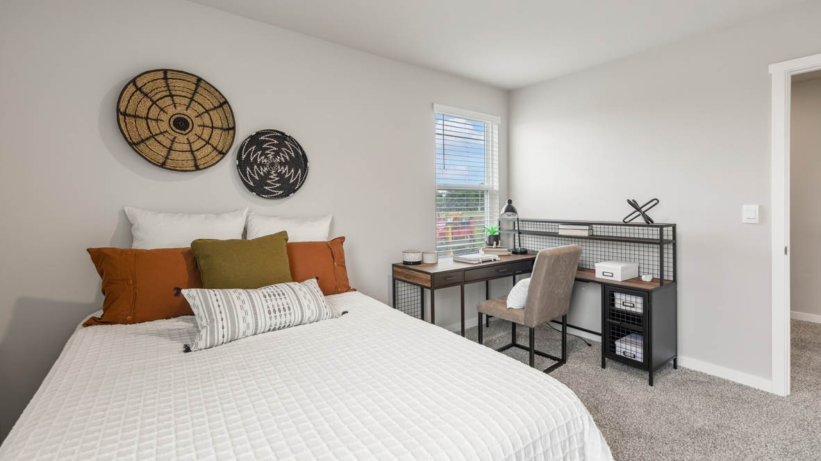 Comfortable secondary bedroom with natural light, modern finishes, and versatile living space.