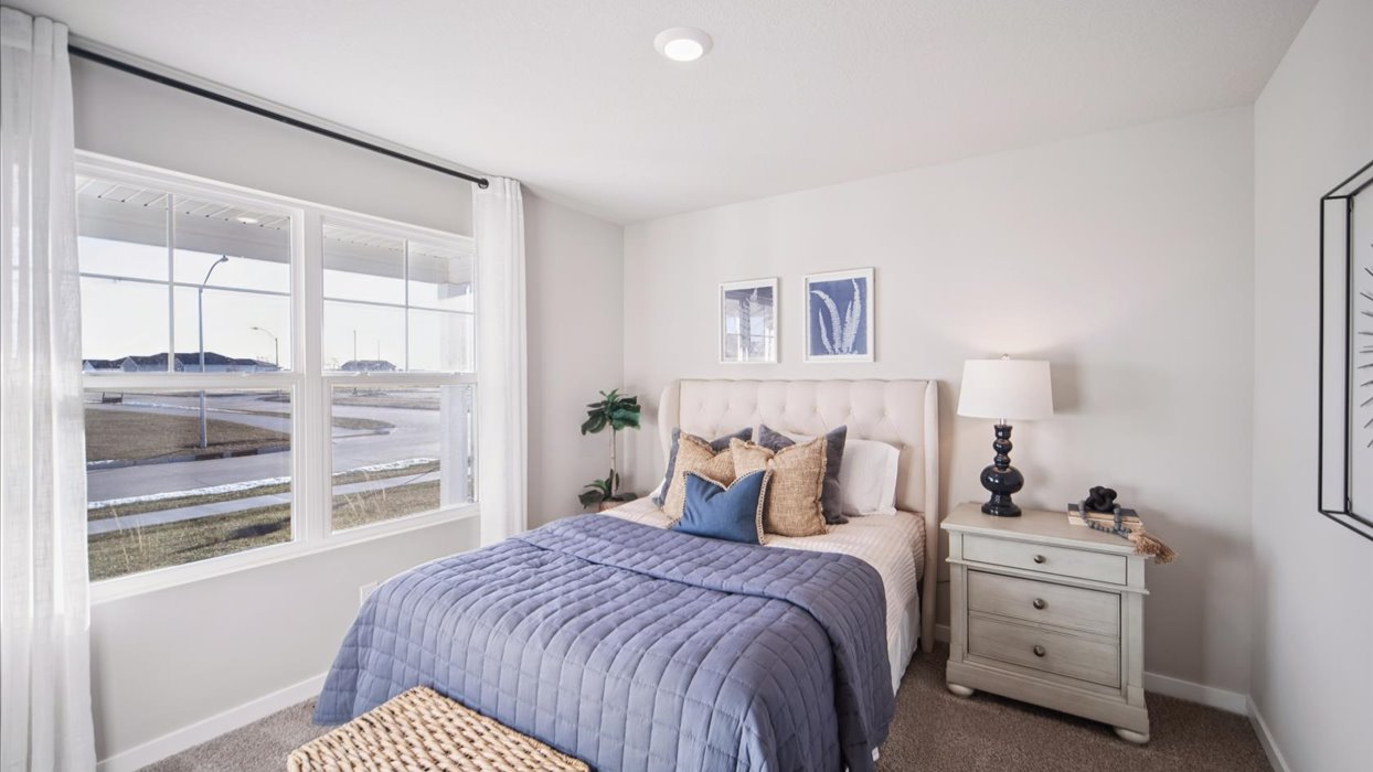 Comfortable secondary bedroom with natural light, modern finishes, and versatile living space.