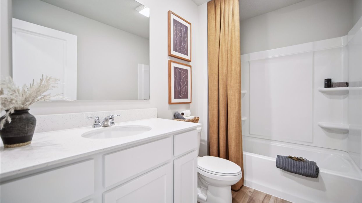 Stylish full bathroom with bright lighting and functional design.