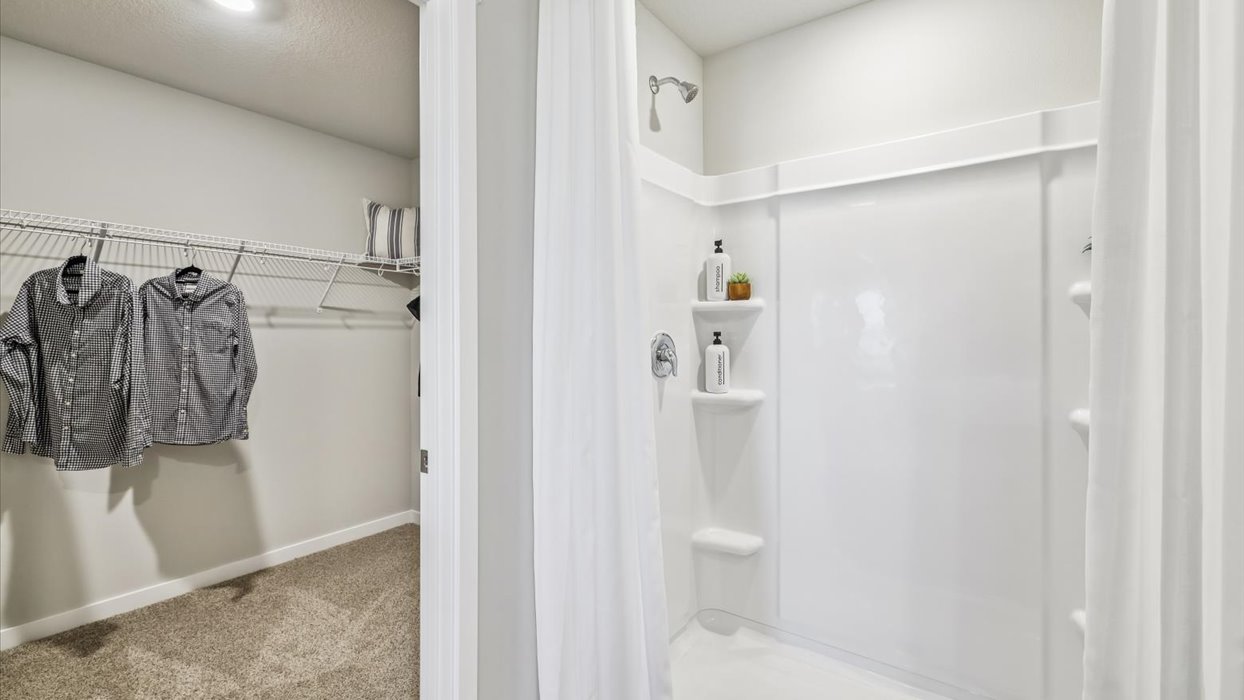 Spacious bathroom with white cabinetry and double sinks