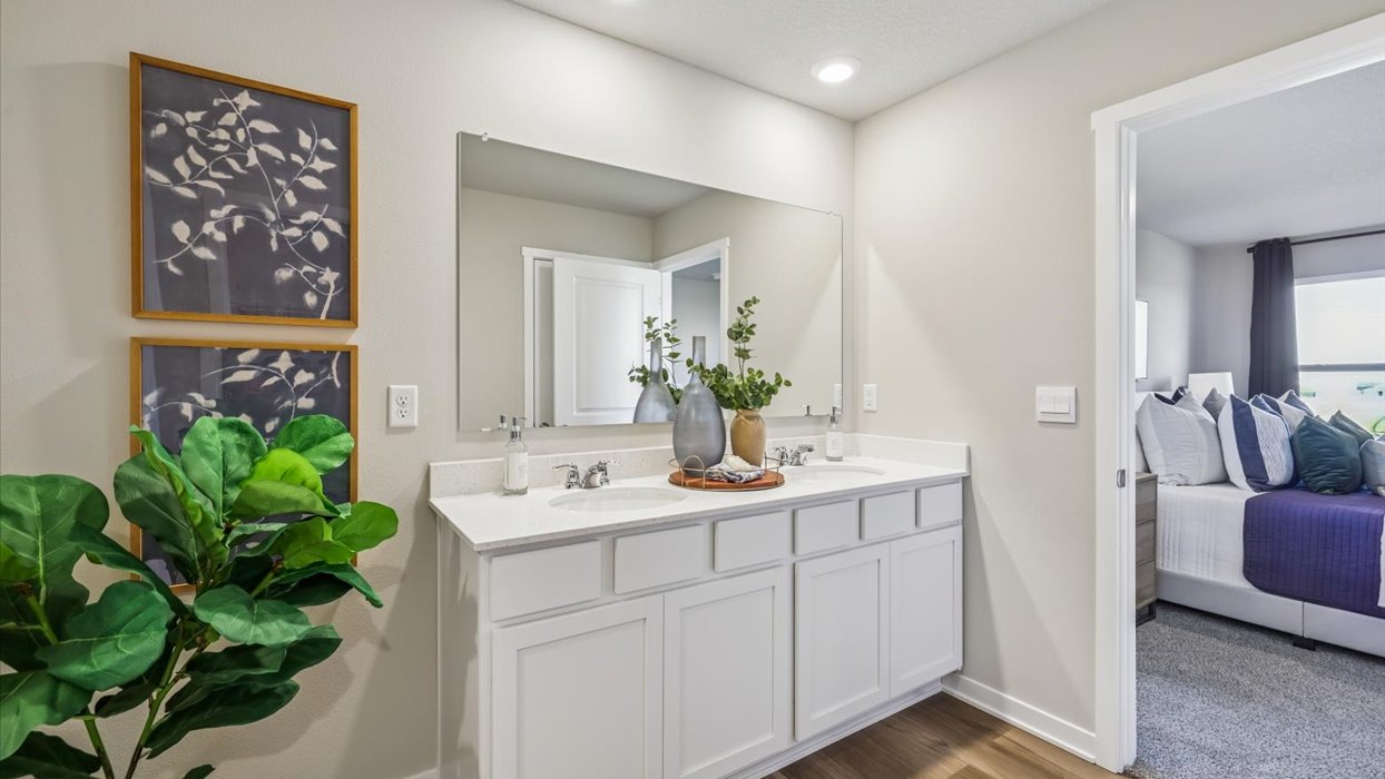 Spacious bathroom with white cabinetry and double sinks