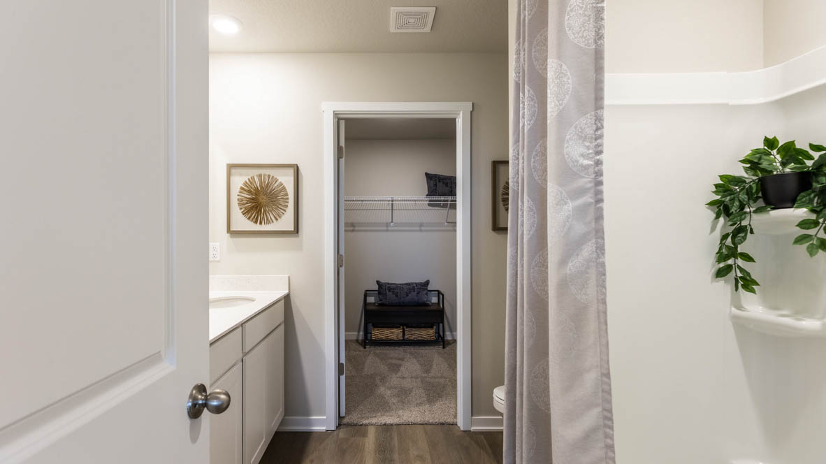 Spacious bathroom with white cabinetry and double sinks