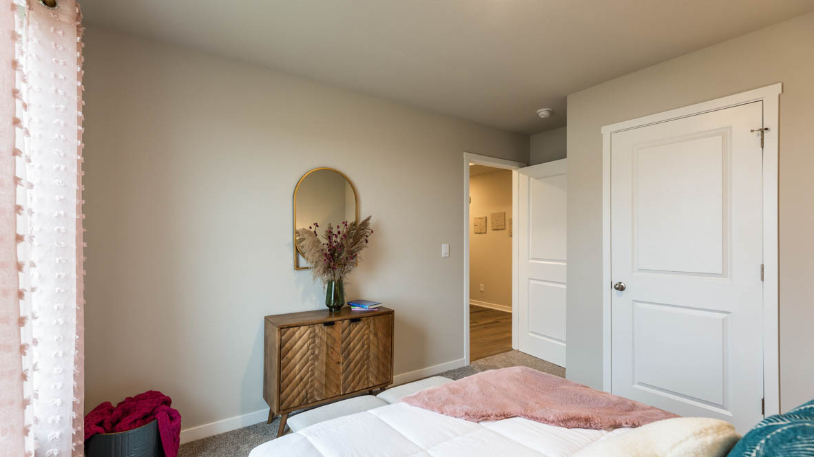Comfortable secondary bedroom with natural light, modern finishes, and versatile living space.