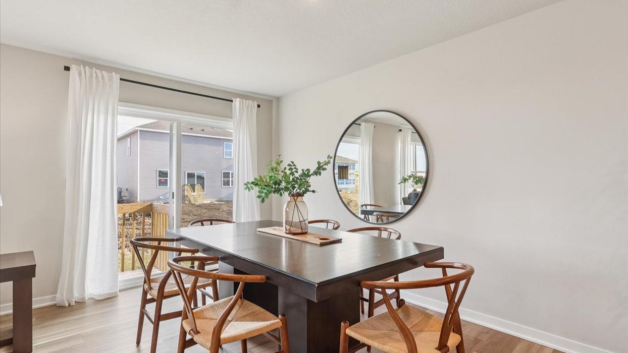roland dining area with black table next to sliding glass doors