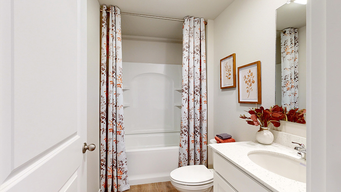 Stylish full bathroom with bright lighting and functional design.