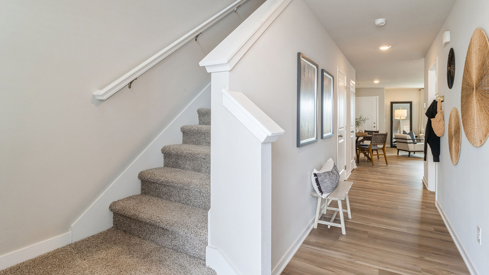 Welcoming townhouse entry hall with a half bathroom tucked just off the main walkway.