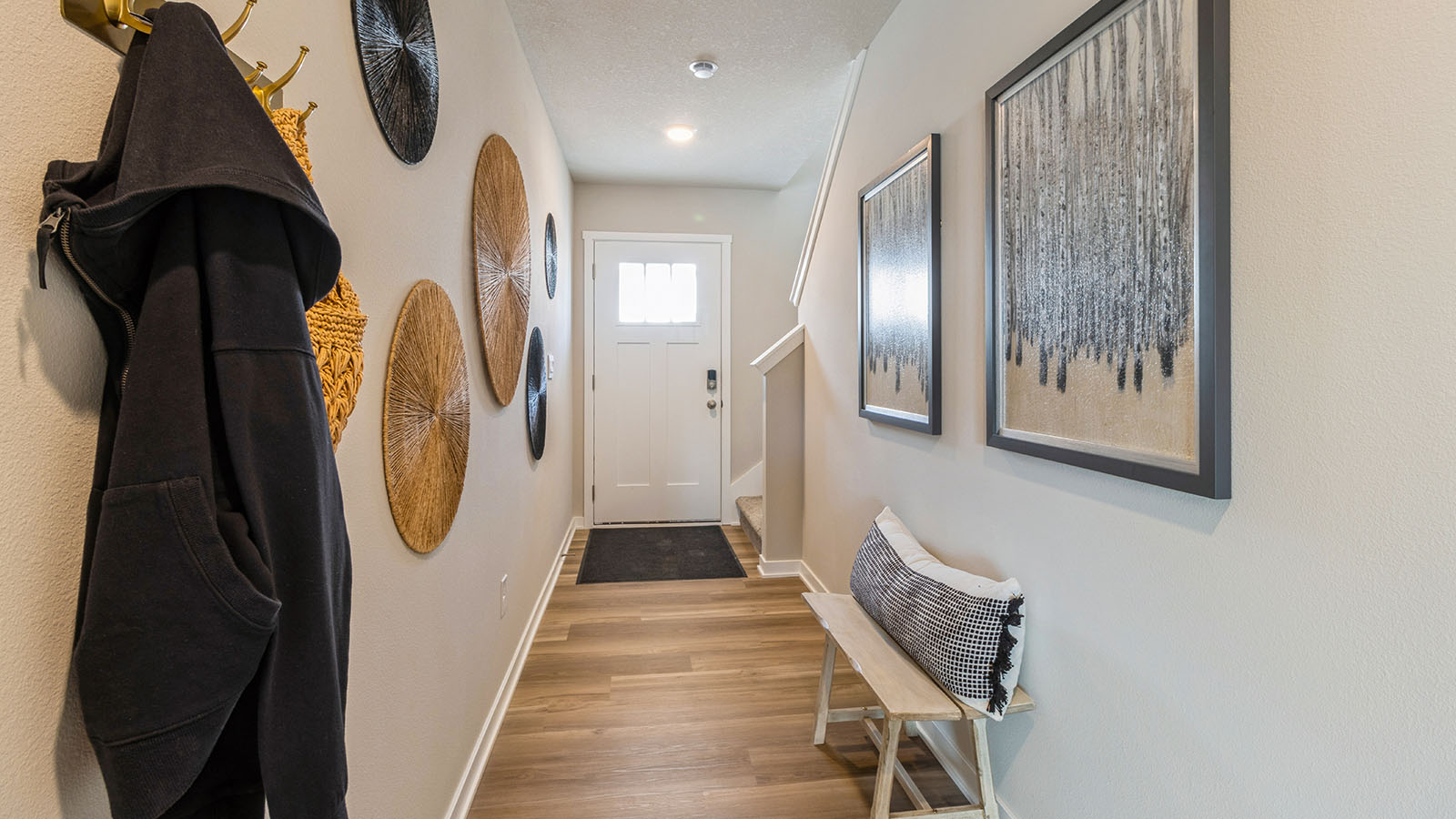 Welcoming townhouse entry hall with a half bathroom tucked just off the main walkway.