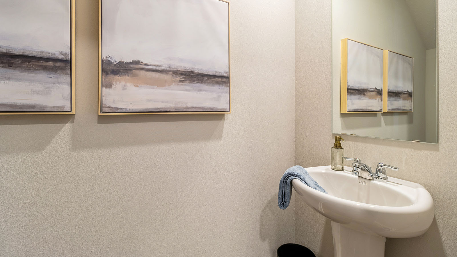Convenient main-level powder room with updated fixtures and bright lighting.
