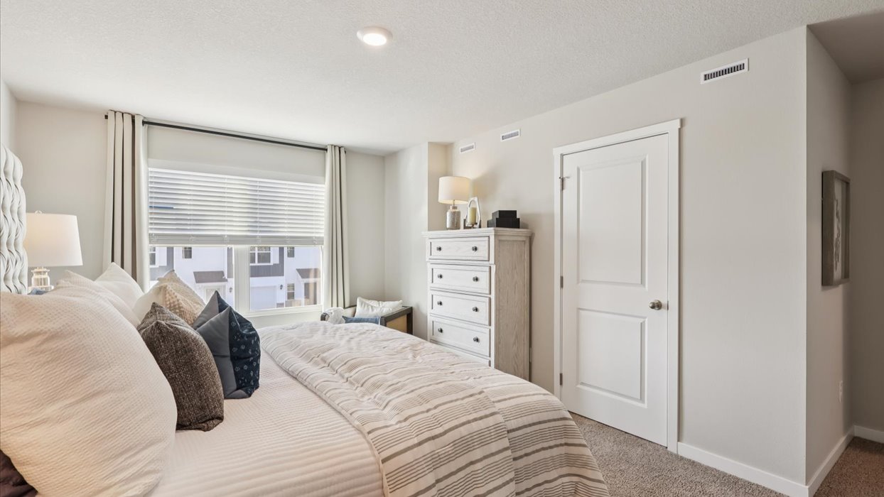 Primary bedroom with natural lighting and spacious layout