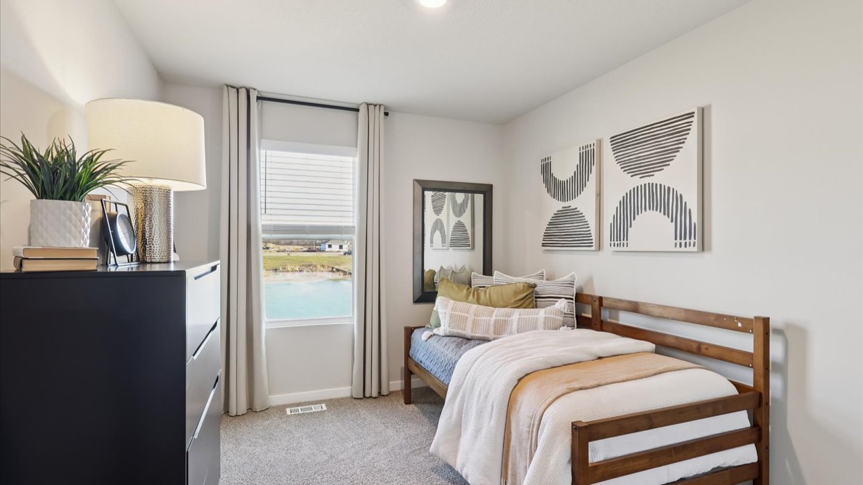 Comfortable secondary bedroom with natural light, modern finishes, and versatile living space.