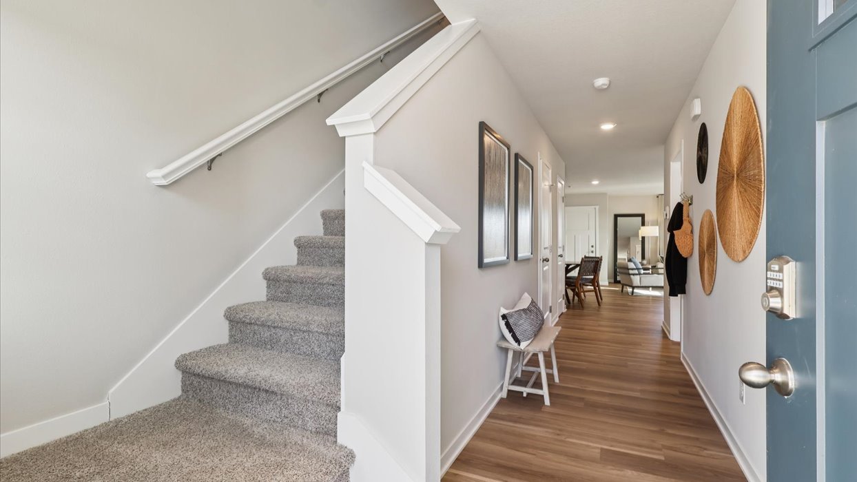 Welcoming townhouse entry hall with a half bathroom tucked just off the main walkway.