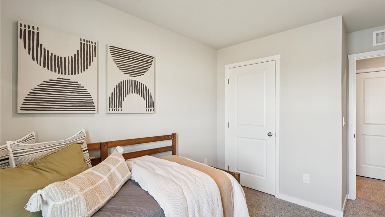 Comfortable secondary bedroom with natural light, modern finishes, and versatile living space.