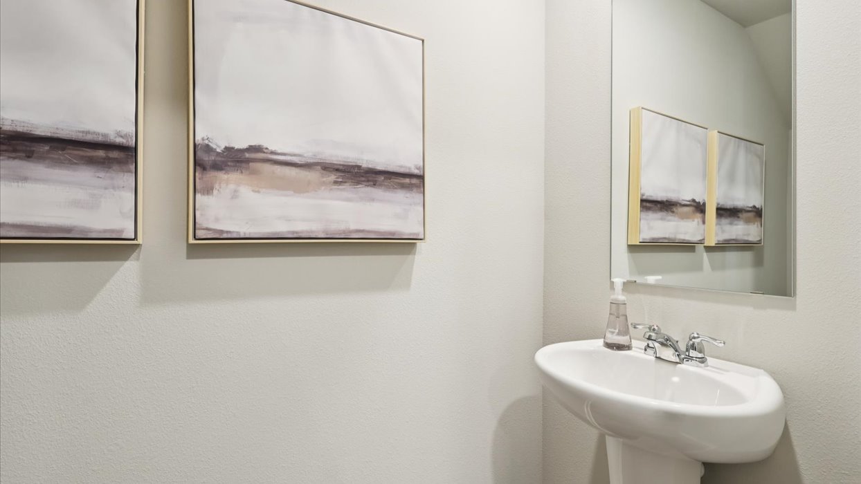 Convenient main-level powder room with updated fixtures and bright lighting.