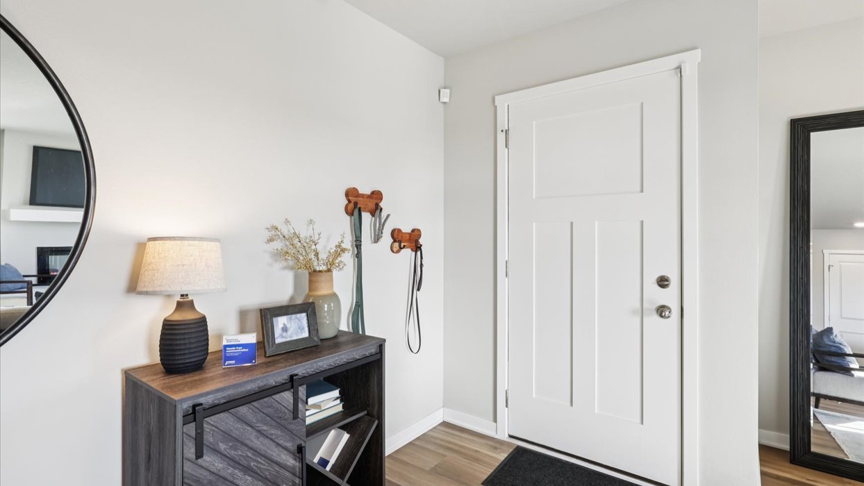 Welcoming townhouse entry hall with a half bathroom tucked just off the main walkway.