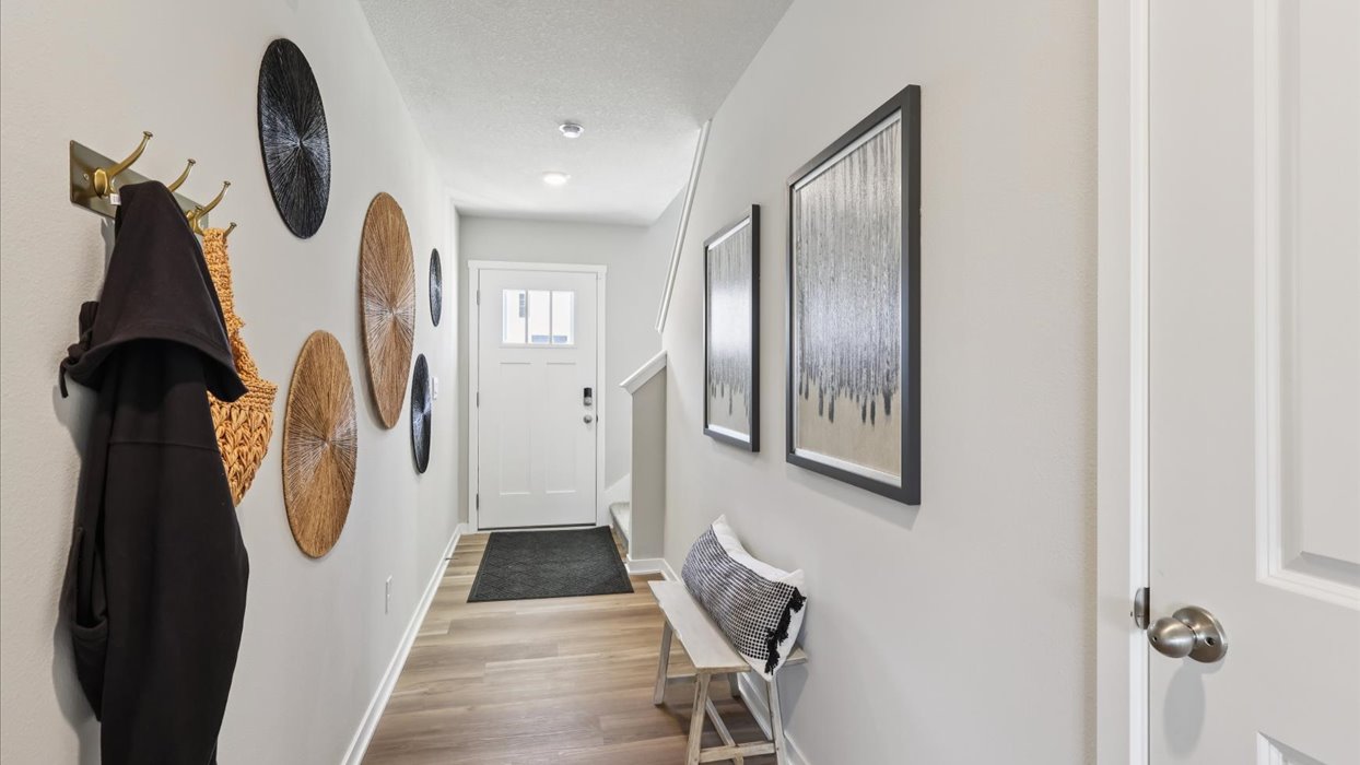 Welcoming townhouse entry hall with a half bathroom tucked just off the main walkway.