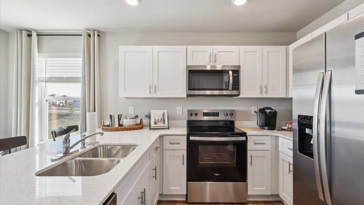 Kitchen with white cabinetry and quartz countertop
