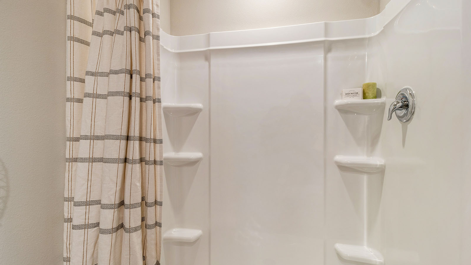 Spacious primary bathroom featuring dual vanities, modern fixtures, and a walk-in shower.
