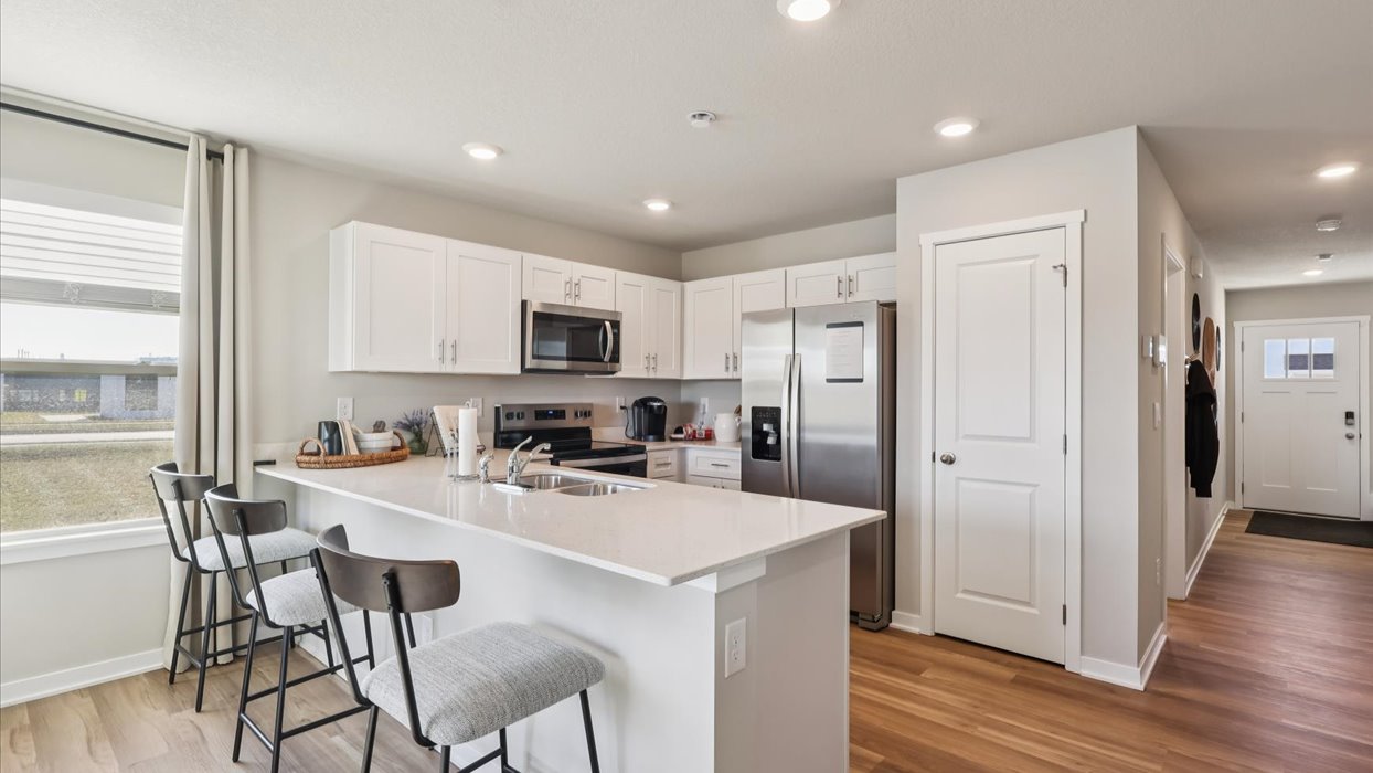 Kitchen with white cabinetry and quartz countertop