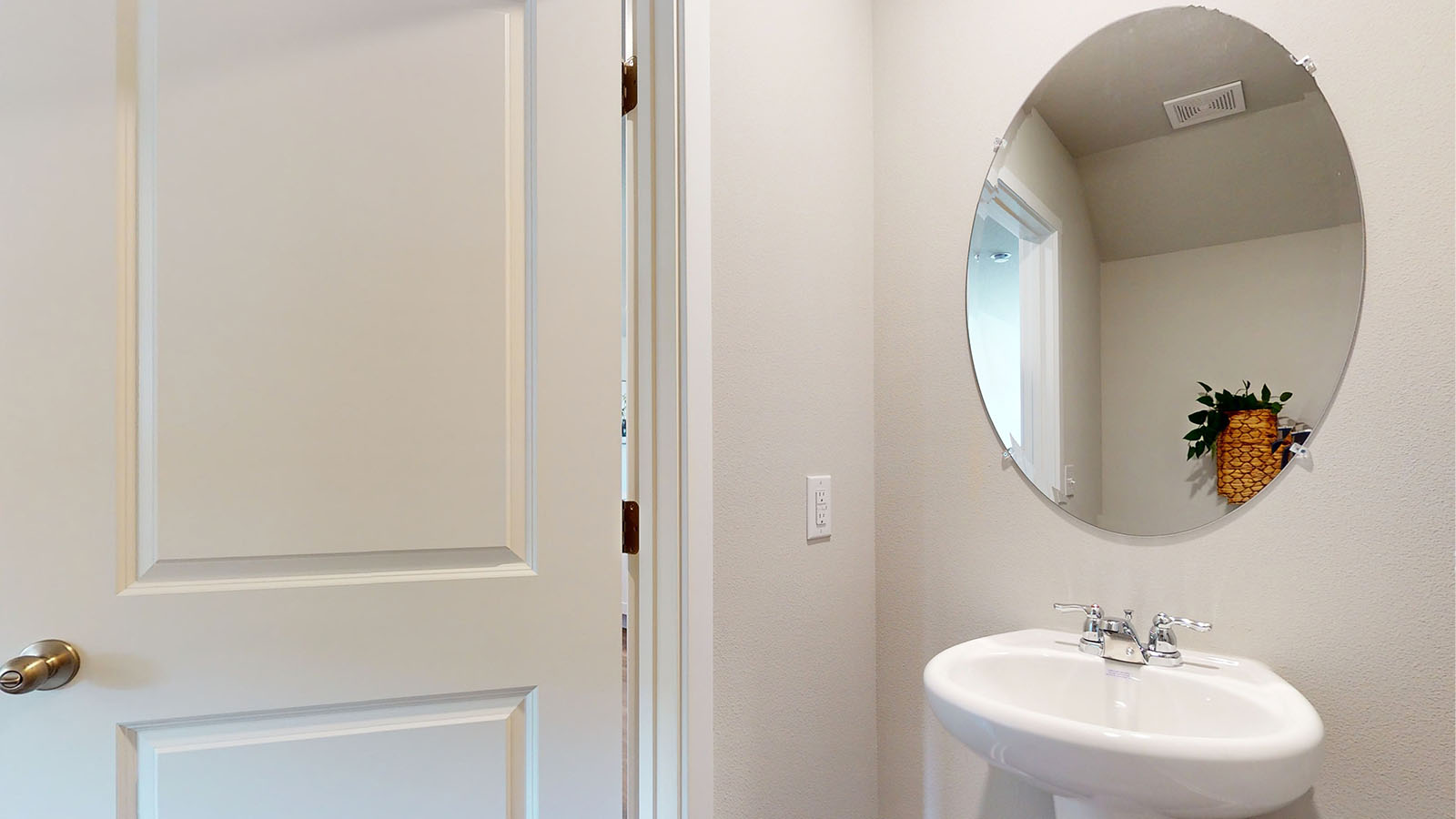 Convenient main-level powder room with updated fixtures and bright lighting.