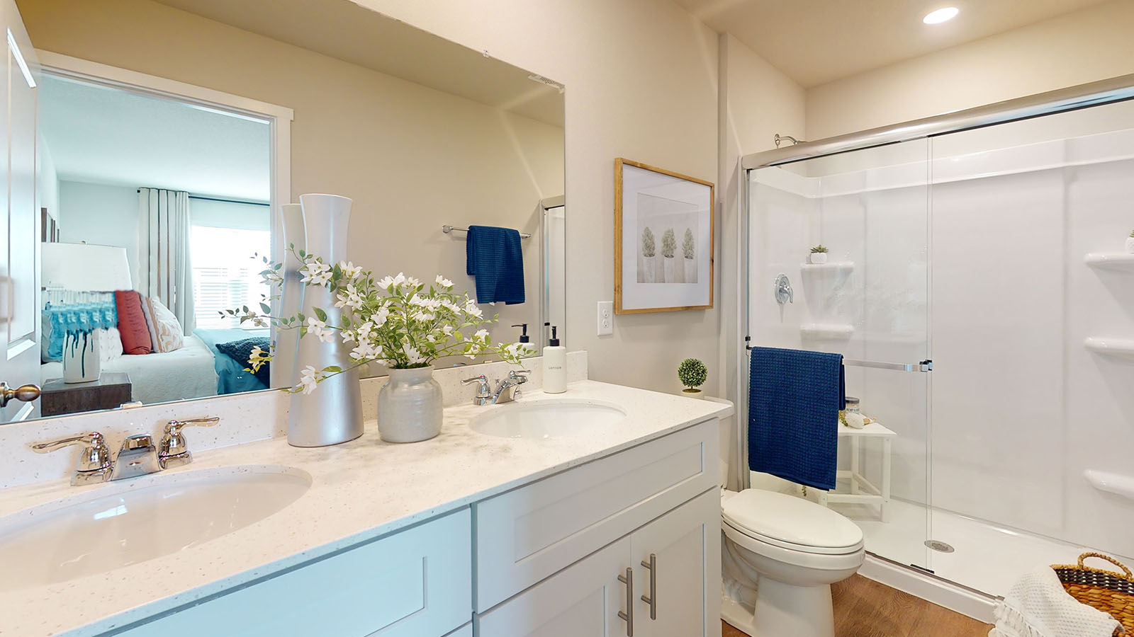 Spacious primary bathroom featuring dual vanities, modern fixtures, and a walk-in shower.