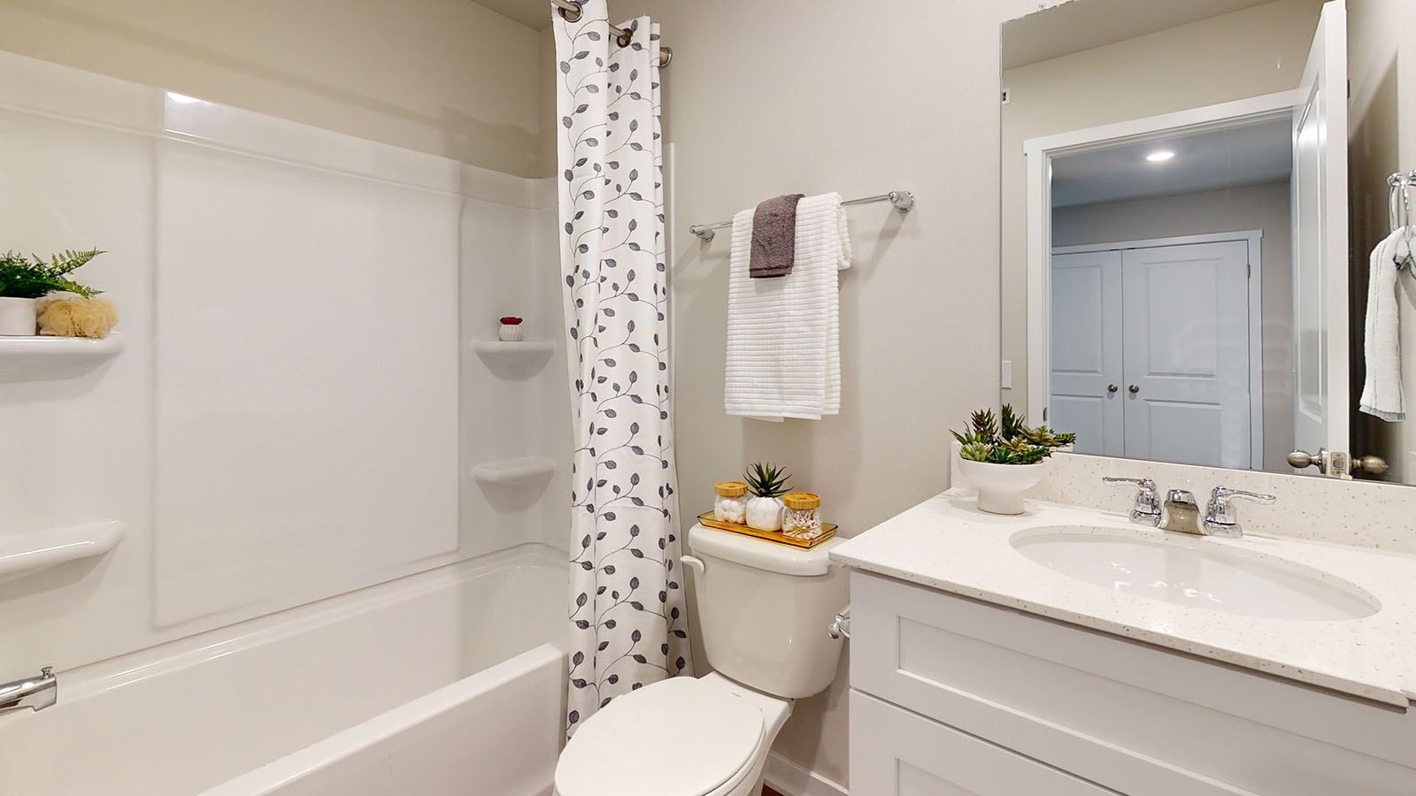 Stylish full bathroom with bright lighting and functional design.