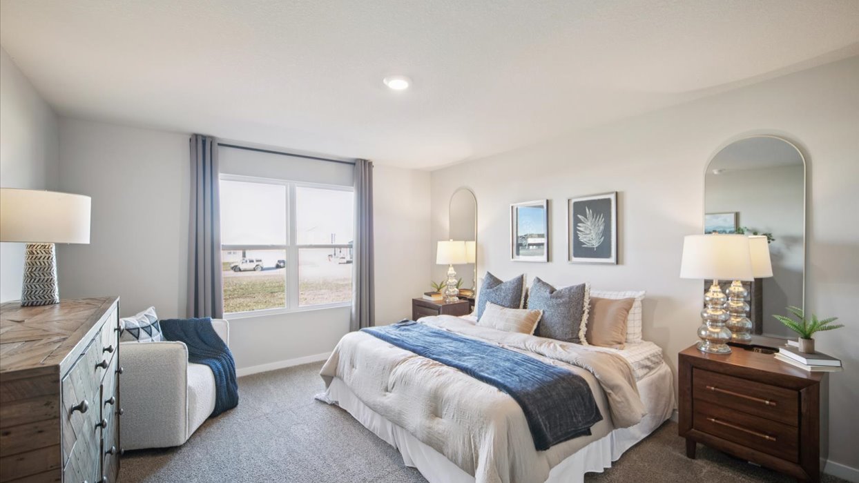 spacious primary bedroom with large window