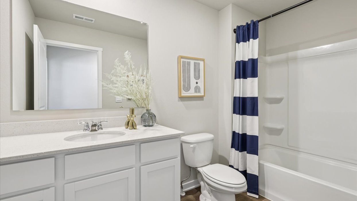 Bathroom with tub and shower combo, quartz countertops, and white vanity