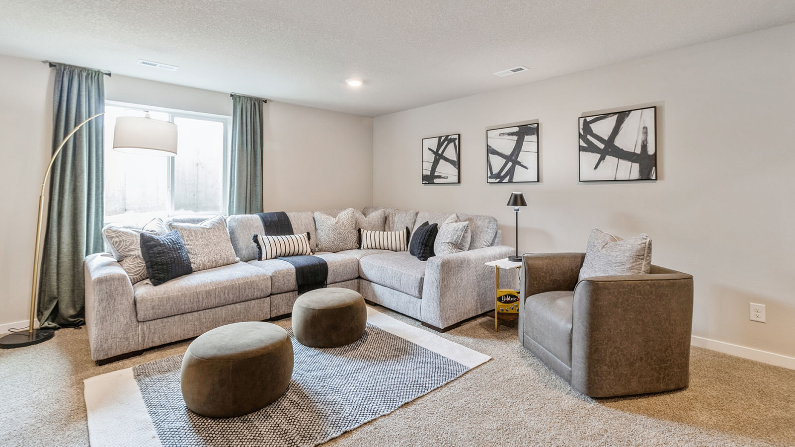 Finished basement living area with comfortable seating space and flexible room for entertaining or relaxing.