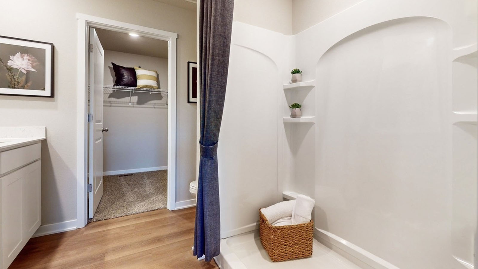 Spacious primary bathroom featuring dual vanities, modern fixtures, and a walk-in shower.