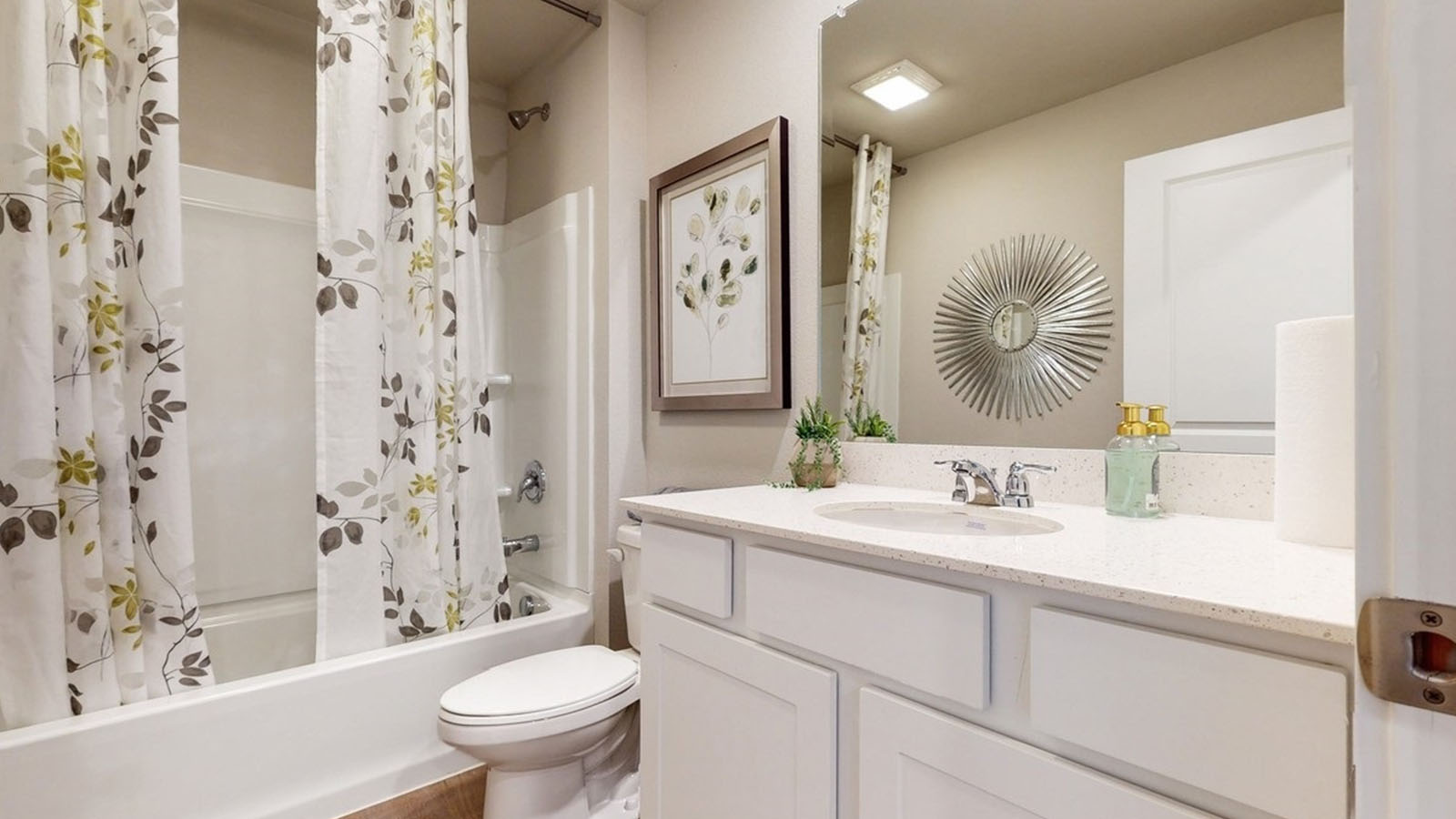 Stylish full bathroom with bright lighting and functional design.