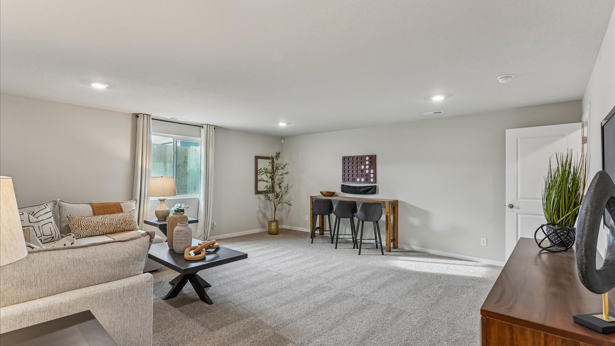 Finished basement living area with comfortable seating space and flexible room for entertaining or relaxing.