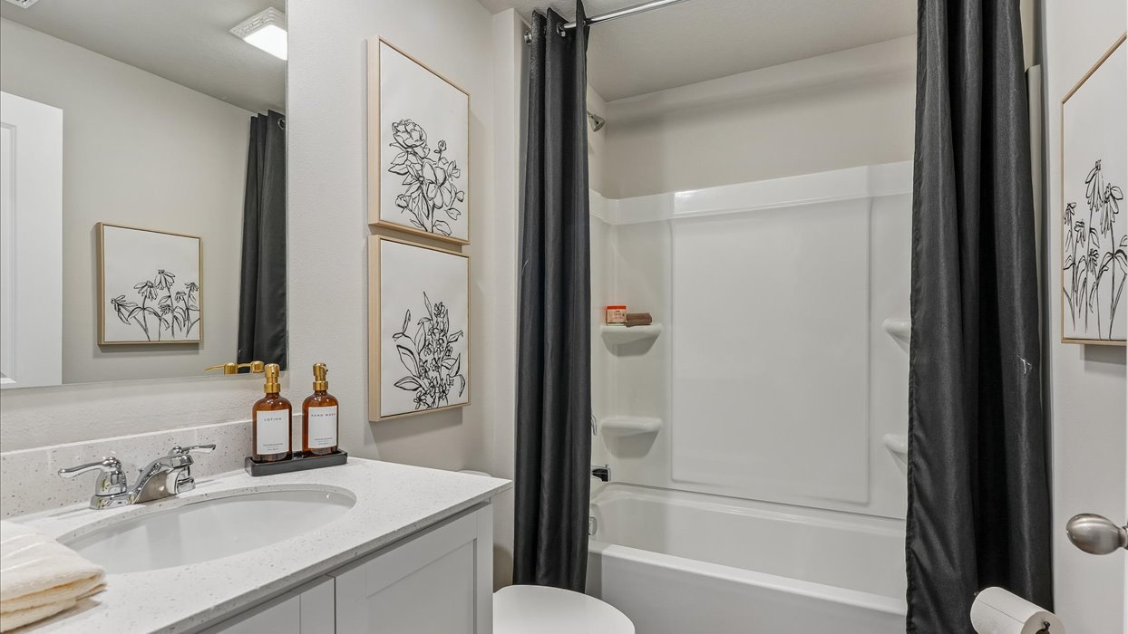 Stylish lower-level bathroom featuring contemporary fixtures and convenient access from the finished basement.
