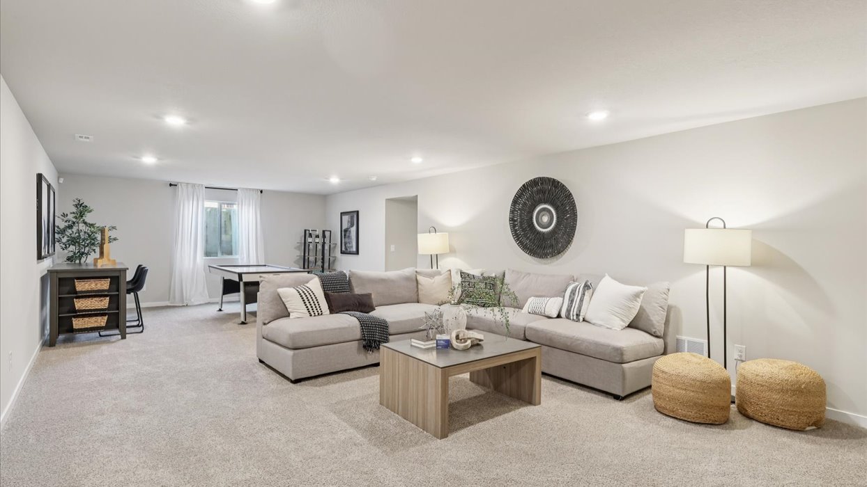 Finished basement living area with comfortable seating space and flexible room for entertaining or relaxing.
