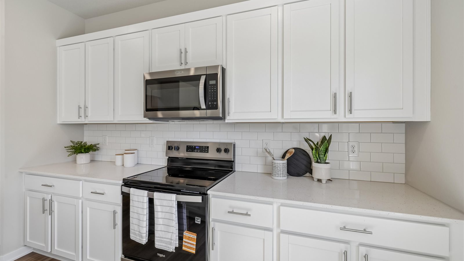 Kitchen with white cabinetry and quartz countertop