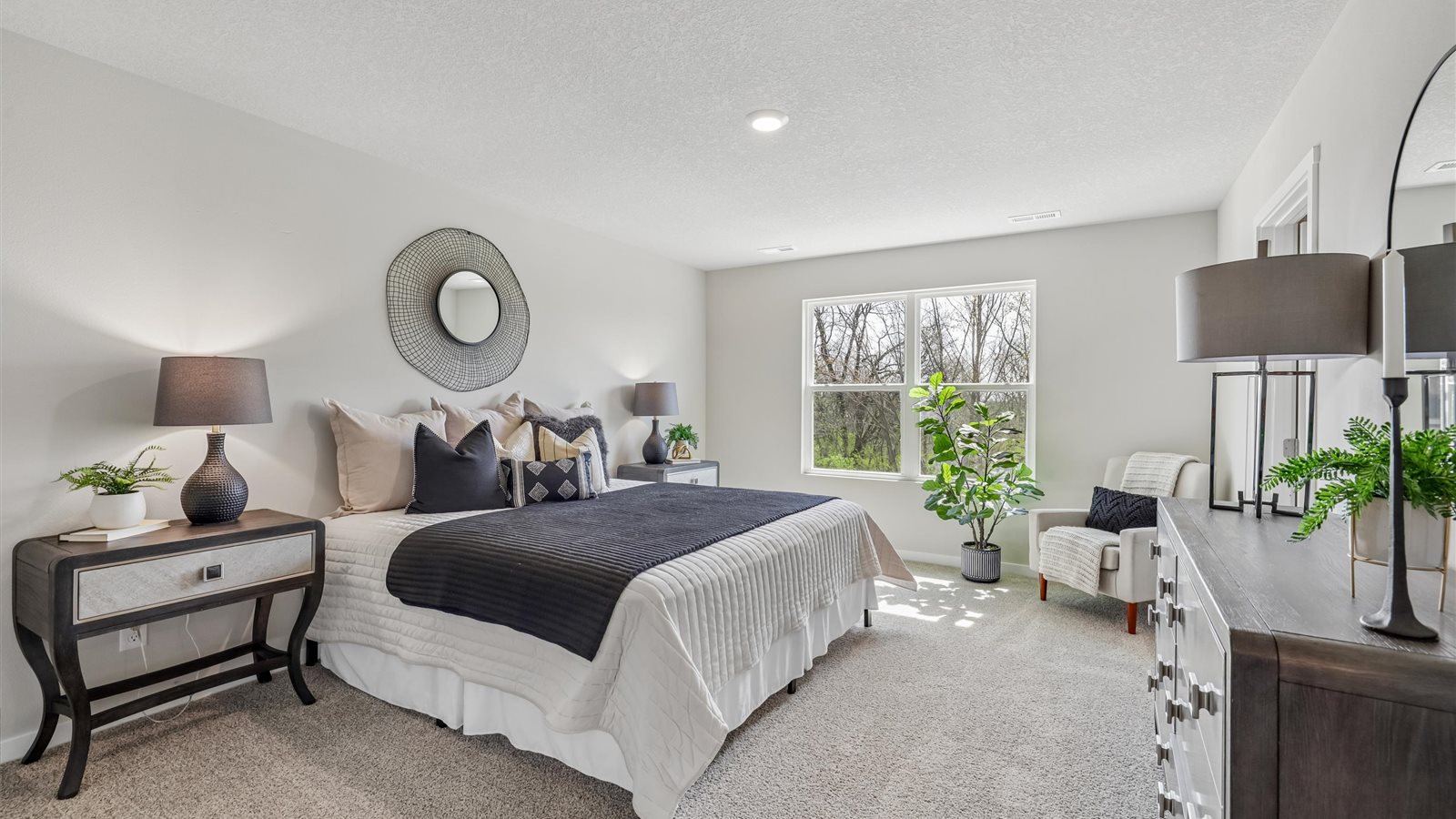 Spacious primary suite with natural light, attached bathroom, & walk in closet