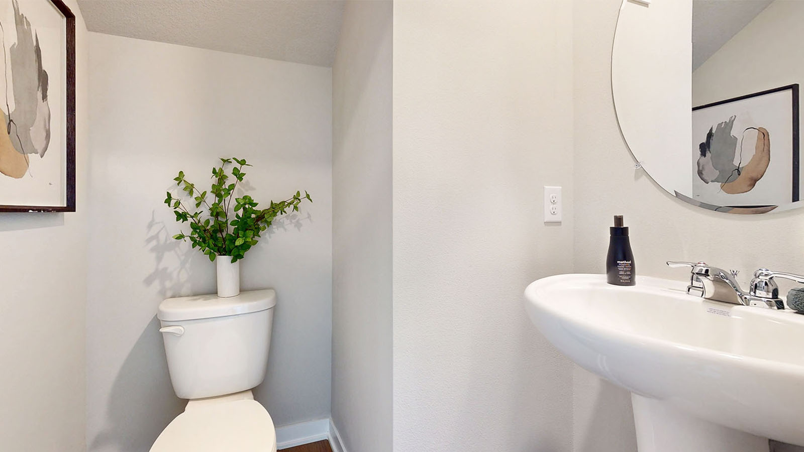 Convenient main-level powder room with updated fixtures and bright lighting.
