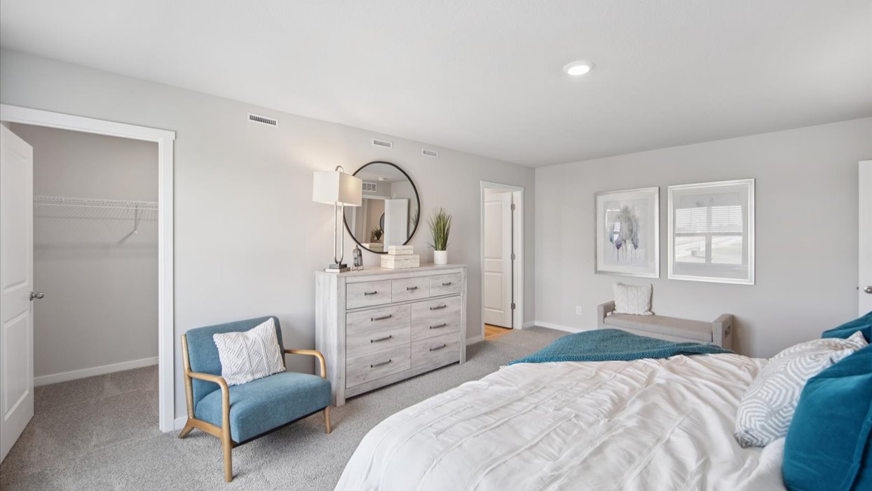 Spacious primary suite with natural light, attached bathroom, & walk in closet