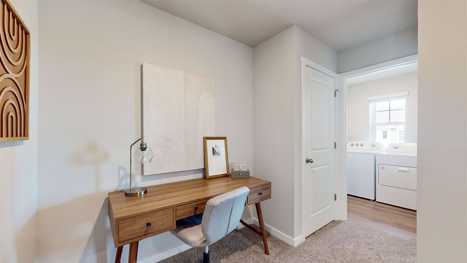 Hallway leading to laundry room and primary room