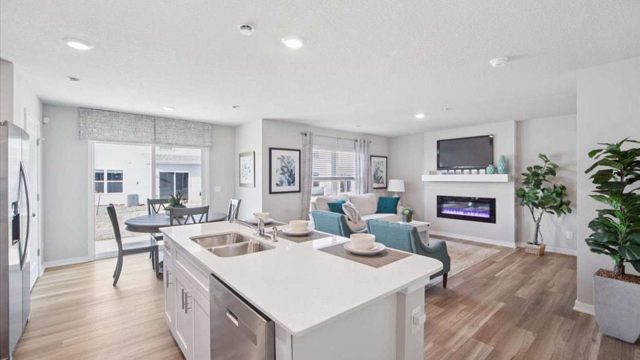 Kitchen with stainless steel appliances, quartz countertops, and white cabinetry