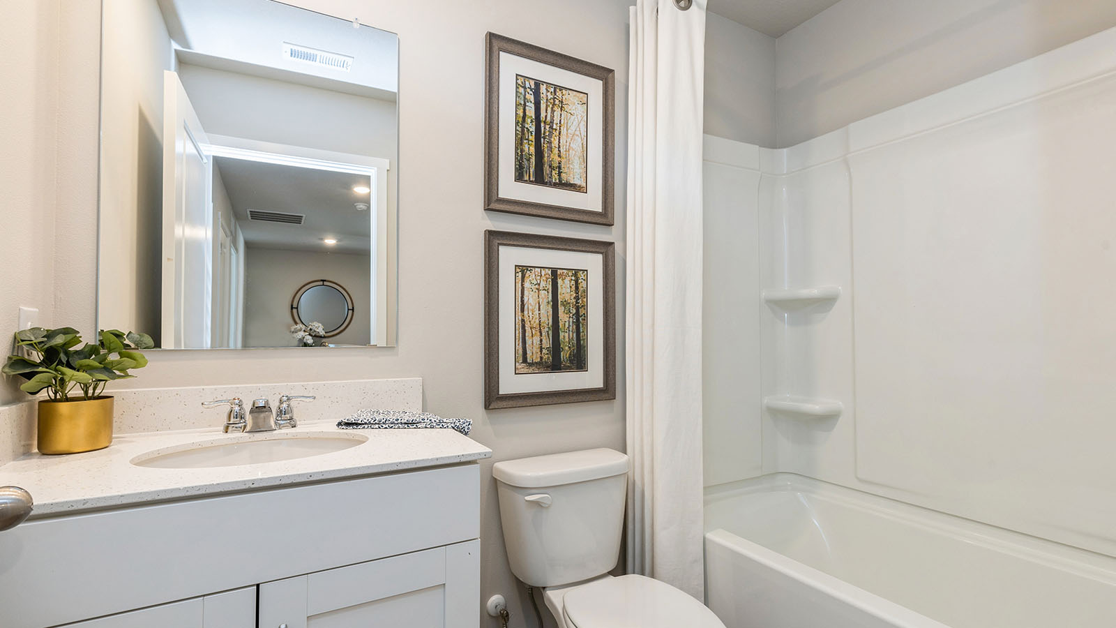 Bathroom with tub and shower combo, quartz countertops, and white vanity