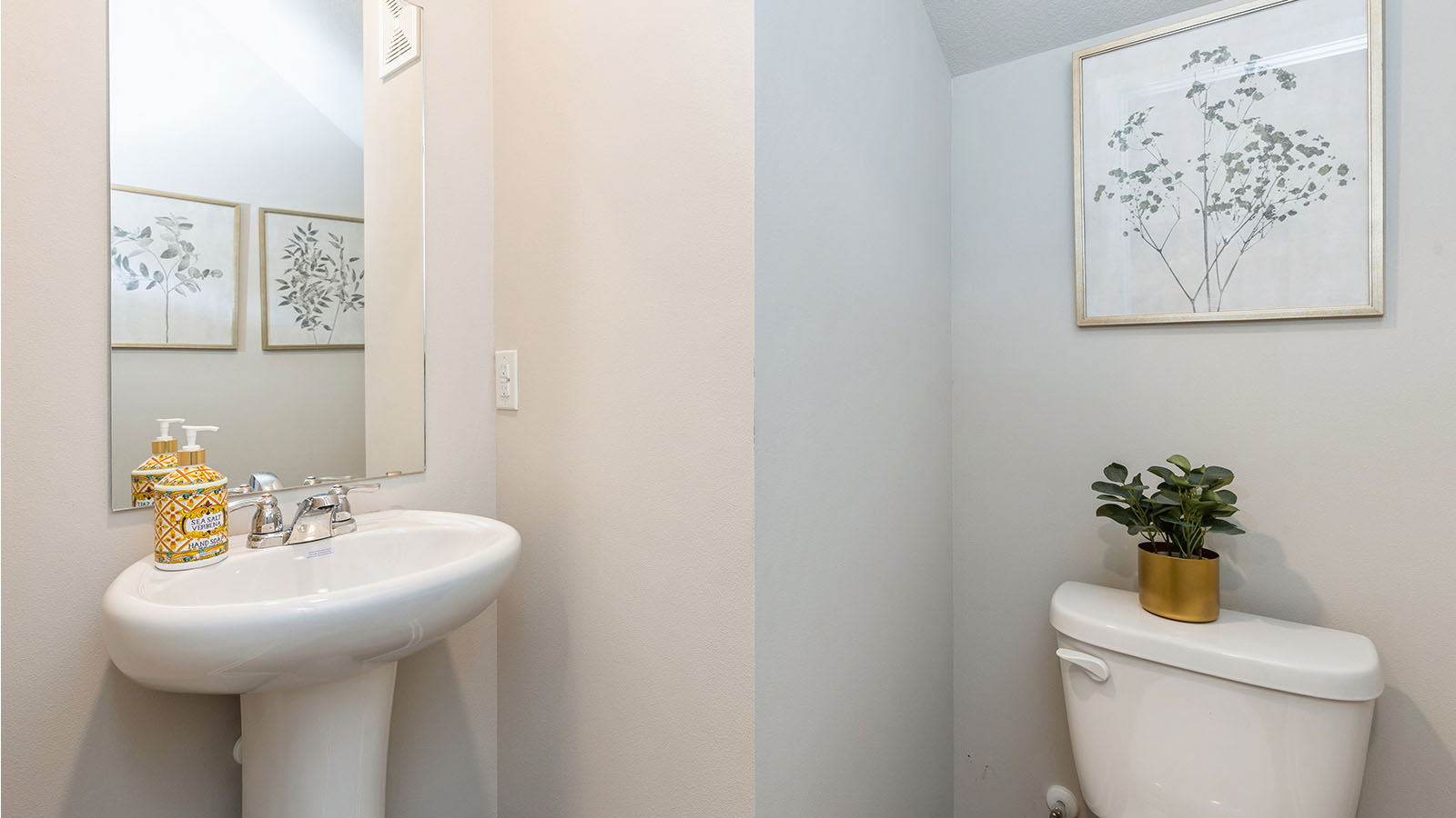 Convenient main-level powder room with updated fixtures and bright lighting.